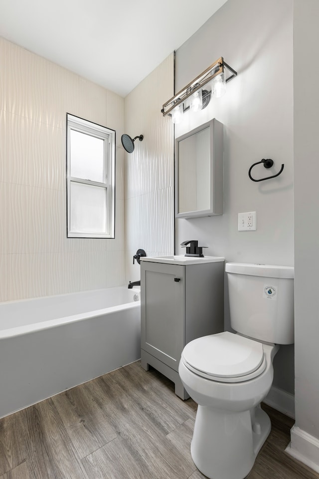 full bathroom with vanity, toilet, bathtub / shower combination, and hardwood / wood-style floors