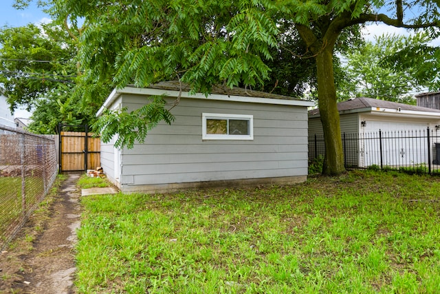 rear view of property with a yard and an outbuilding