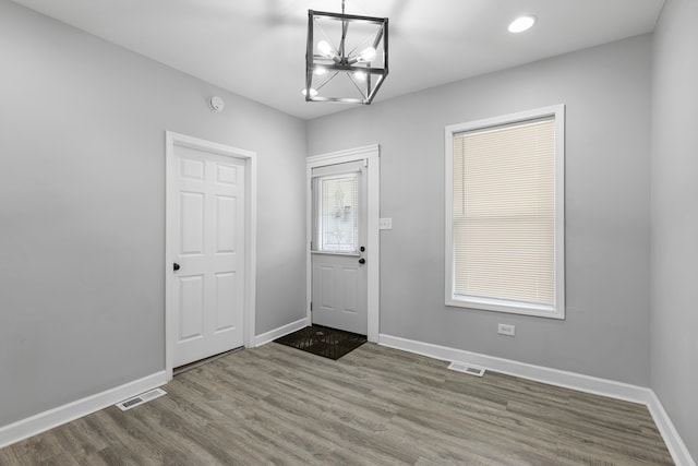 foyer featuring dark hardwood / wood-style flooring and a notable chandelier