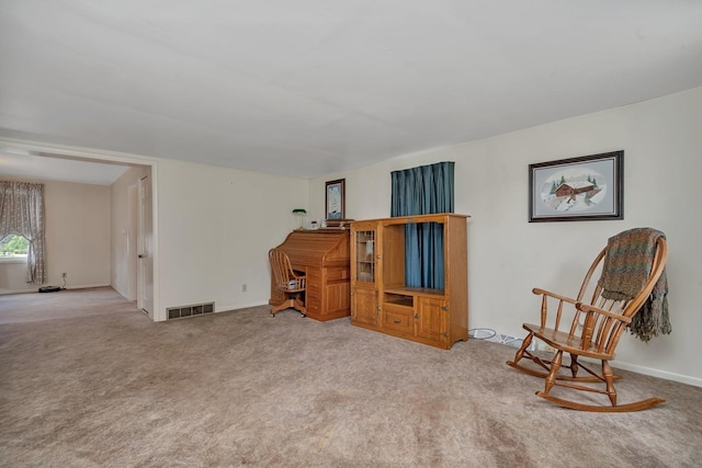 living area with carpet, visible vents, and baseboards