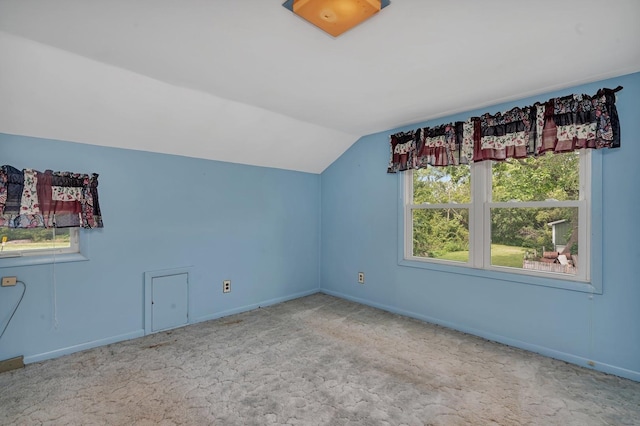 additional living space featuring carpet flooring, vaulted ceiling, and baseboards