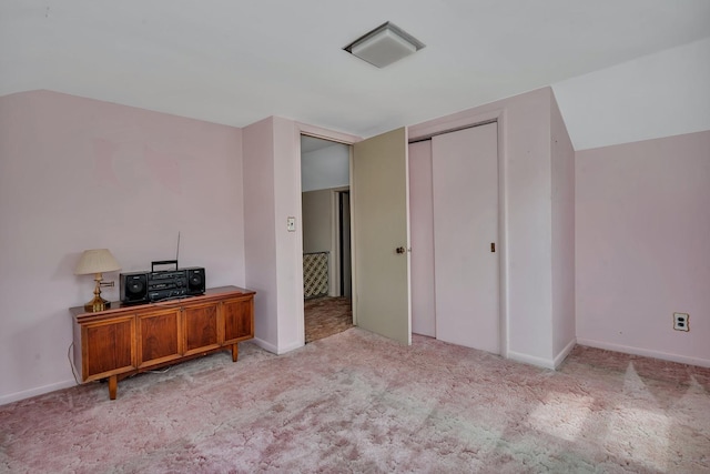 unfurnished bedroom with carpet floors, a closet, visible vents, and baseboards