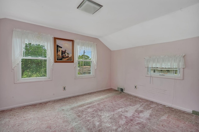 additional living space featuring vaulted ceiling, carpet, visible vents, and baseboards