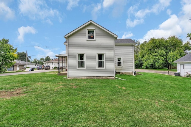 back of house with a yard