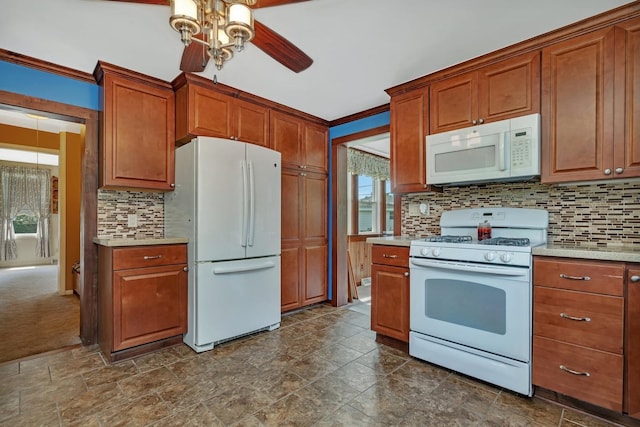 kitchen with light countertops, white appliances, backsplash, and brown cabinets