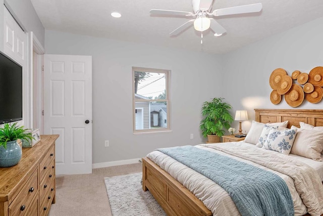 bedroom featuring ceiling fan and light colored carpet