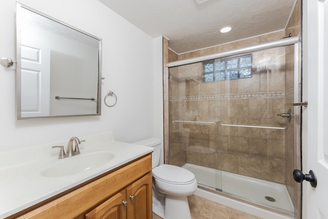 bathroom featuring vanity, an enclosed shower, a textured ceiling, tile patterned floors, and toilet