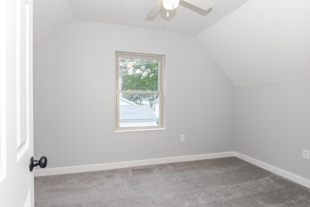 additional living space with lofted ceiling, ceiling fan, and light colored carpet