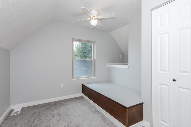 bonus room with lofted ceiling, carpet, ceiling fan, and a textured ceiling