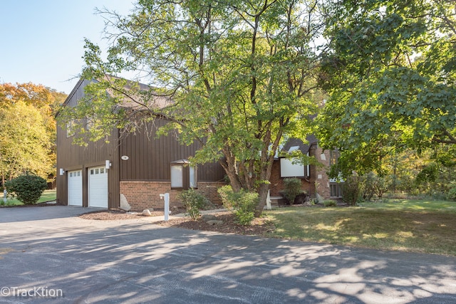 view of front of house with a front yard and a garage