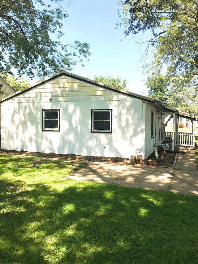 view of side of home featuring a yard