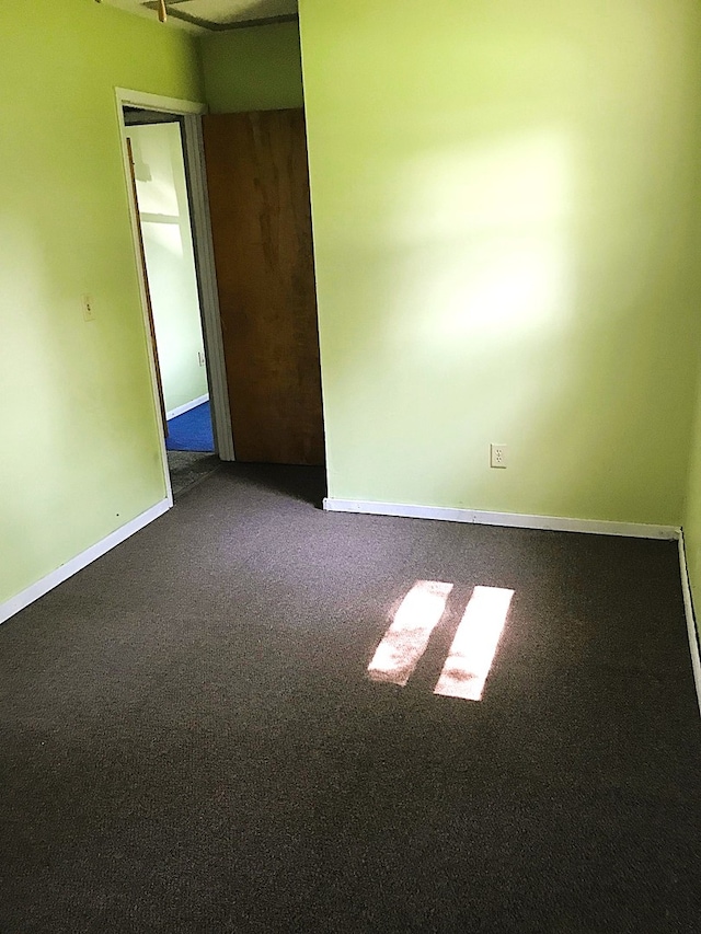 carpeted empty room with baseboards