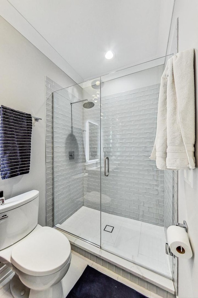 bathroom with walk in shower and toilet