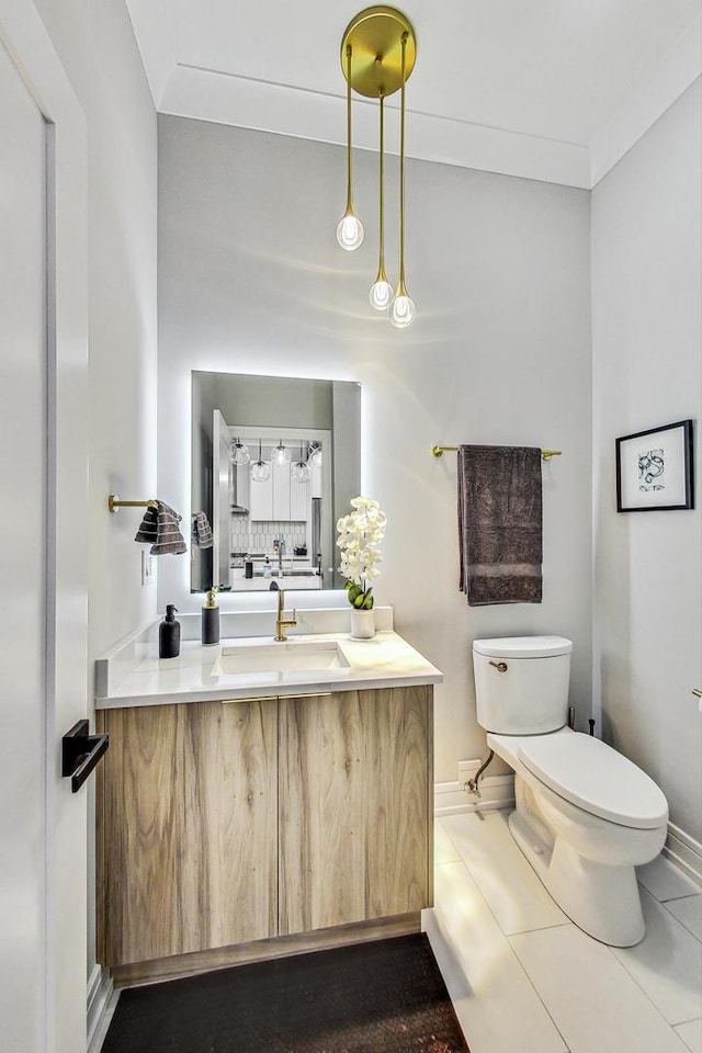 bathroom with tile patterned flooring, vanity, and toilet