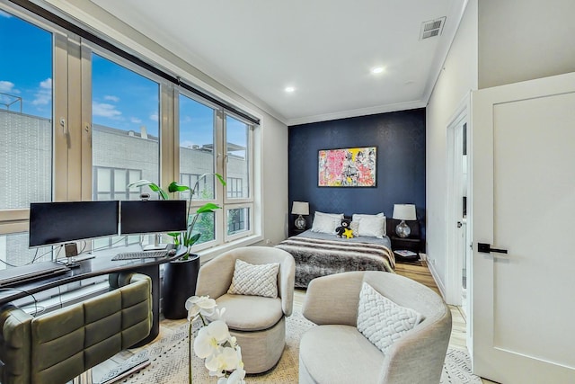 bedroom with hardwood / wood-style flooring and ornamental molding