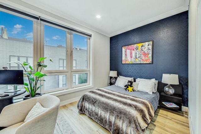 bedroom with wood-type flooring and ornamental molding