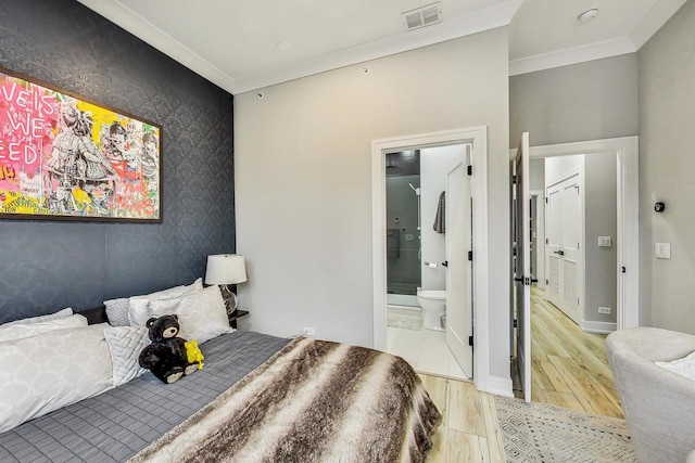 bedroom with ornamental molding, connected bathroom, and light hardwood / wood-style floors