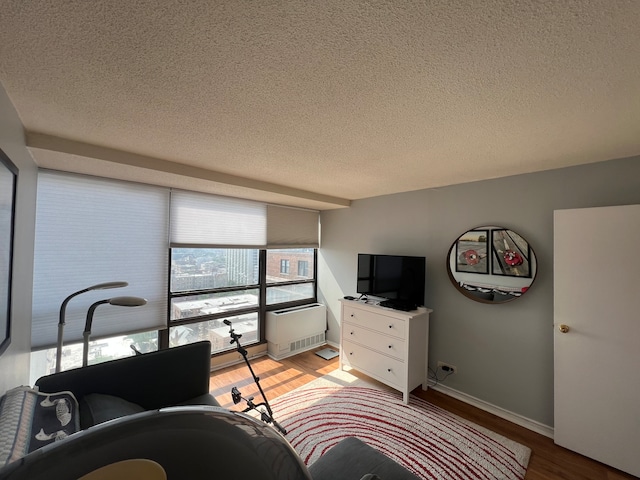 interior space with light hardwood / wood-style floors and a textured ceiling