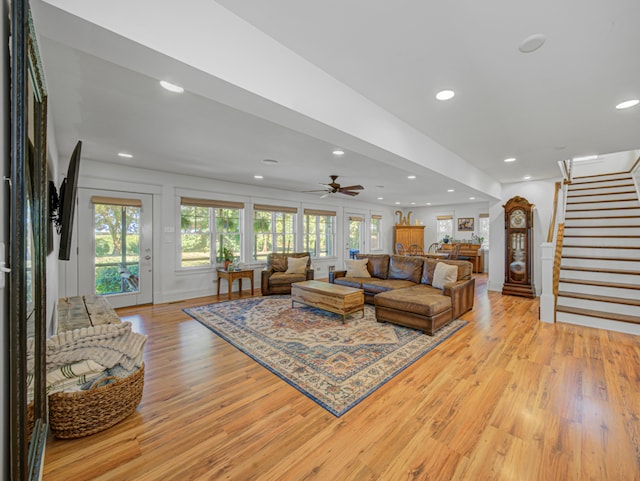 living room featuring light hardwood / wood-style flooring and ceiling fan