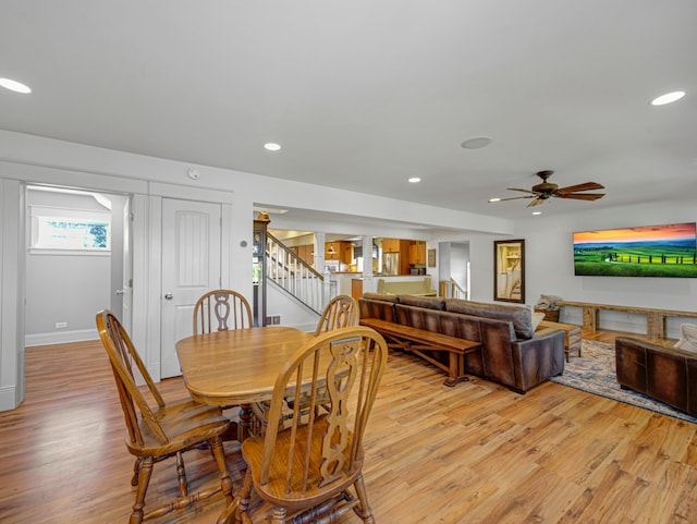 dining area with ceiling fan and light hardwood / wood-style floors