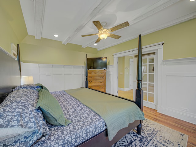 bedroom featuring ceiling fan, beam ceiling, and wood-type flooring