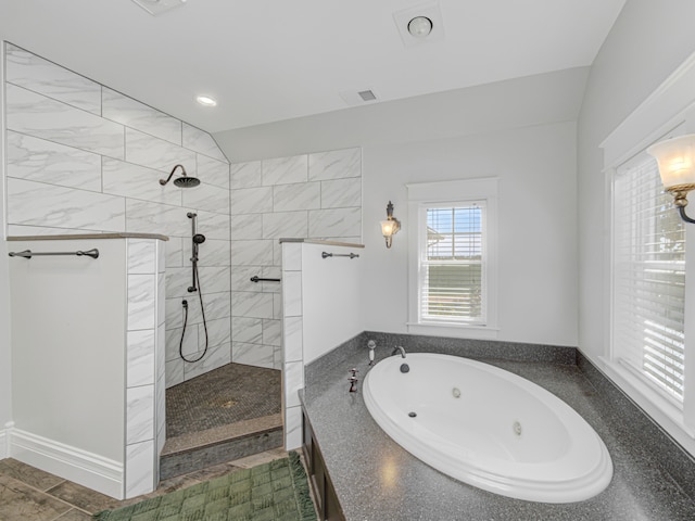 bathroom featuring independent shower and bath