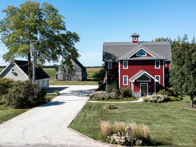 exterior space featuring an outbuilding and a front lawn