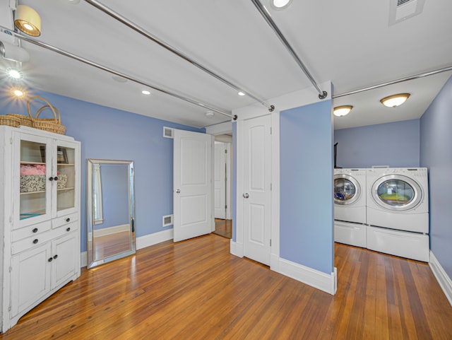 laundry room with washer and clothes dryer and hardwood / wood-style floors