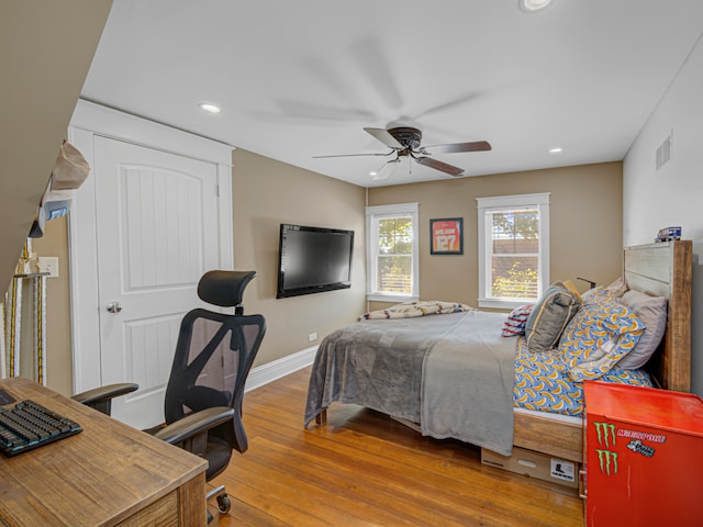 bedroom with ceiling fan and hardwood / wood-style floors