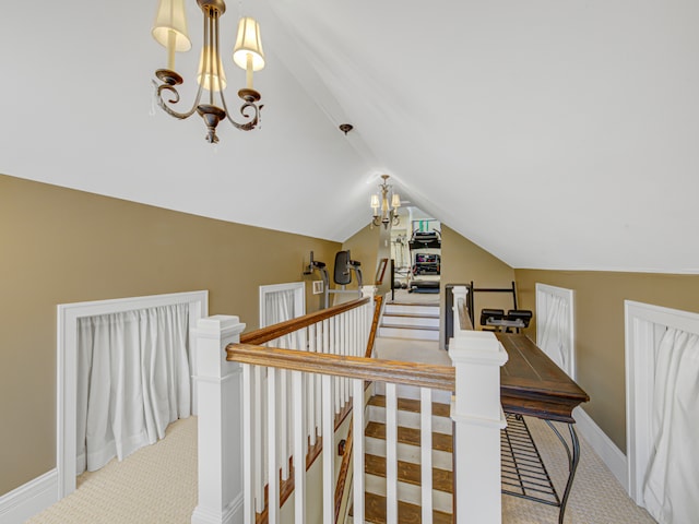 stairs featuring vaulted ceiling, a notable chandelier, and carpet floors