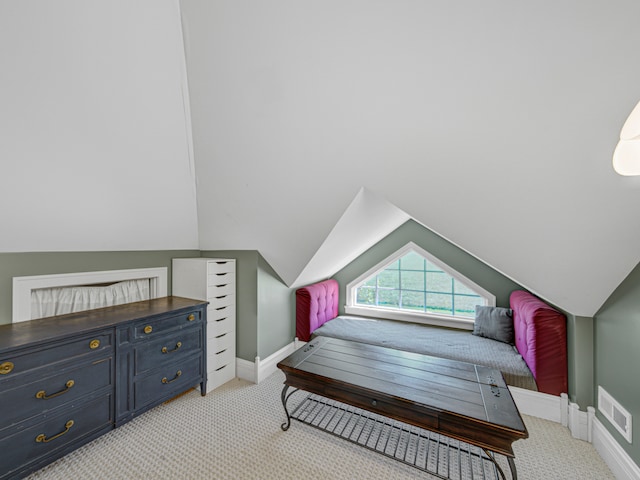 carpeted bedroom featuring lofted ceiling