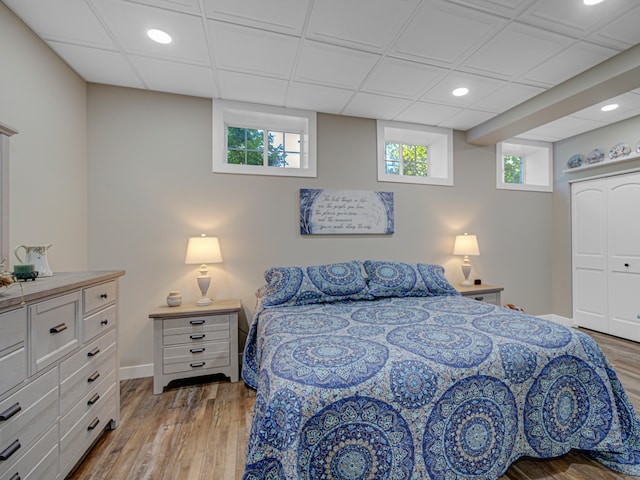 bedroom with hardwood / wood-style floors and a closet