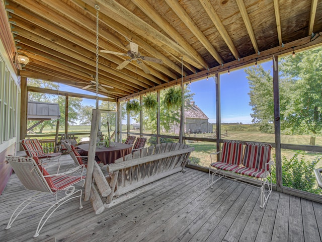 unfurnished sunroom with ceiling fan