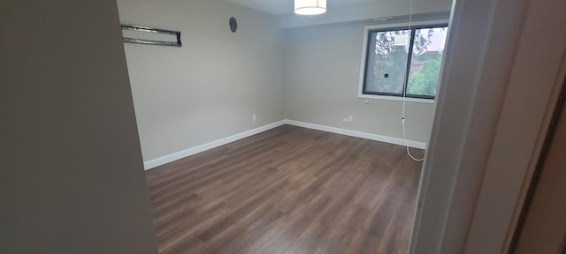 empty room with dark hardwood / wood-style flooring