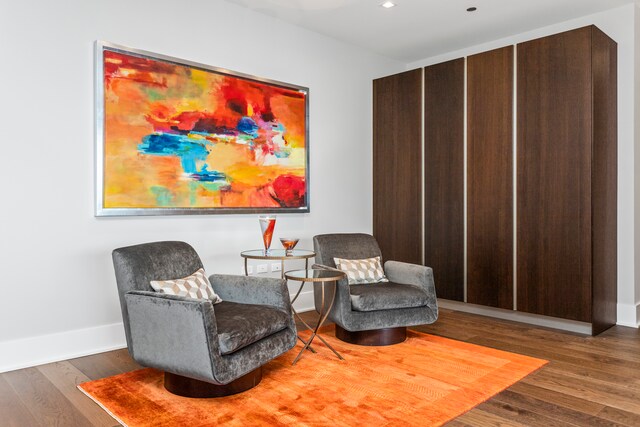 sitting room with dark wood-type flooring