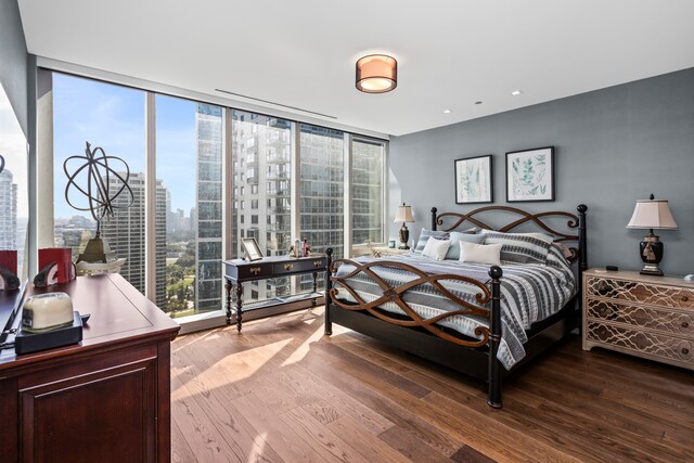 bedroom featuring floor to ceiling windows and hardwood / wood-style floors