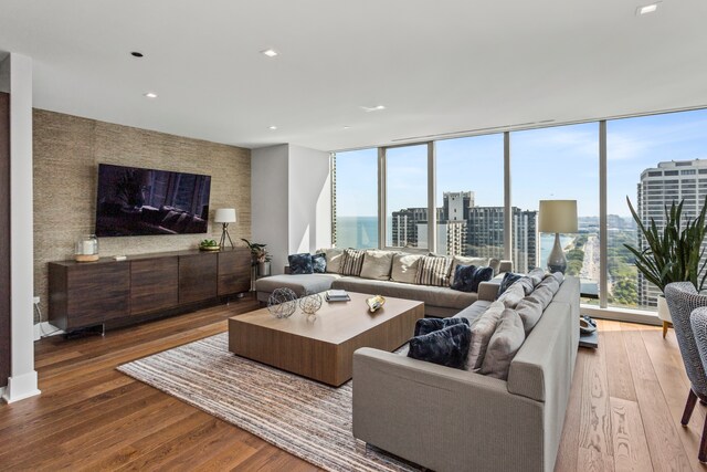 living room featuring wood-type flooring and expansive windows