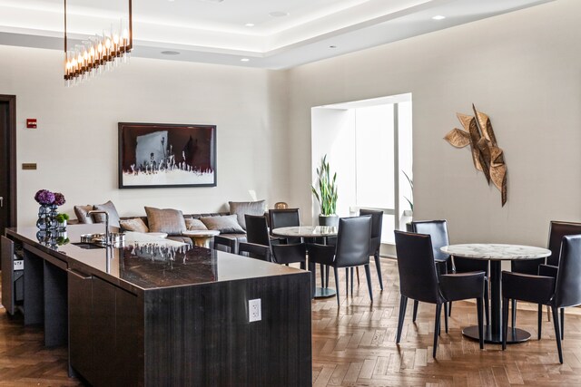 interior space featuring parquet flooring and a notable chandelier