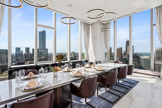 tiled dining area featuring a wall of windows and a chandelier