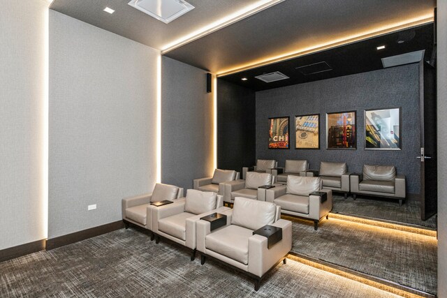 home theater room with dark colored carpet