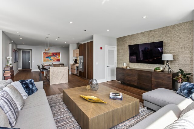 living room with dark hardwood / wood-style flooring and sink