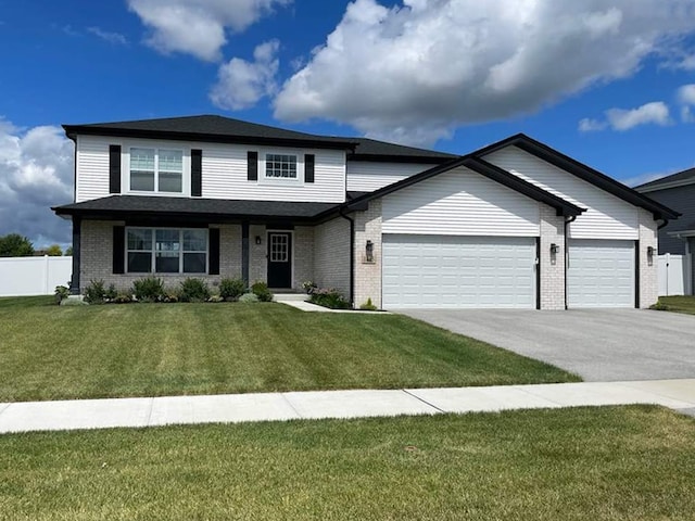 view of front of property with a front yard and a garage