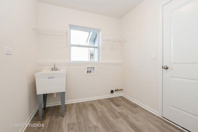 laundry room with light hardwood / wood-style floors and washer hookup