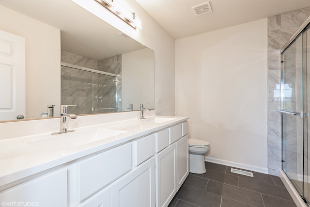 bathroom featuring vanity, toilet, tile patterned flooring, and an enclosed shower