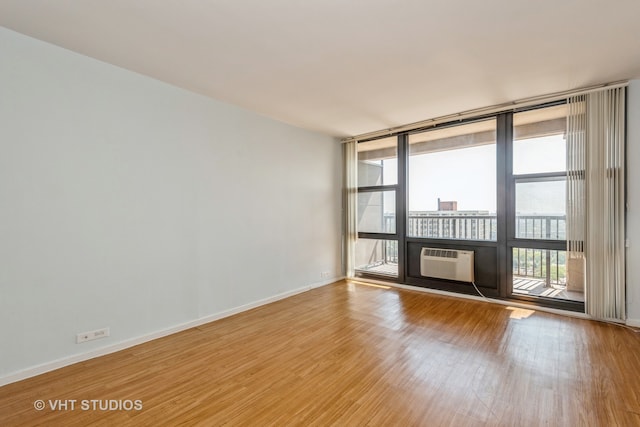 spare room with cooling unit and light hardwood / wood-style floors