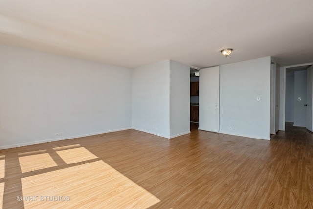 empty room with wood-type flooring