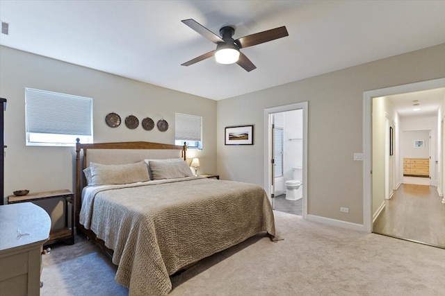 bedroom featuring carpet, ensuite bathroom, and ceiling fan