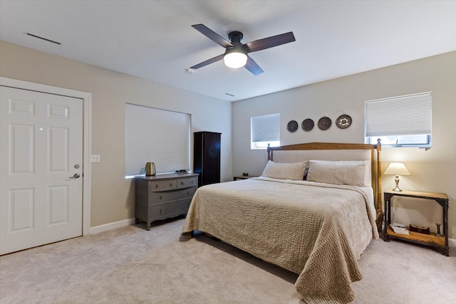 bedroom with ceiling fan and light carpet