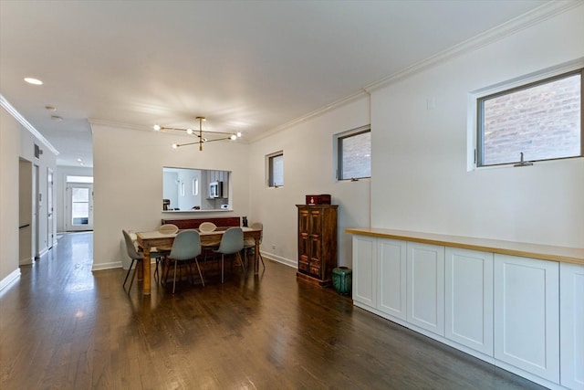 dining space with crown molding, dark wood-type flooring, and a notable chandelier