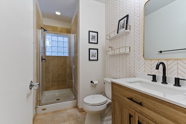 bathroom with tile patterned floors, walk in shower, toilet, and vanity